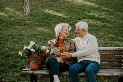 A man and woman are holding a baby and two children.