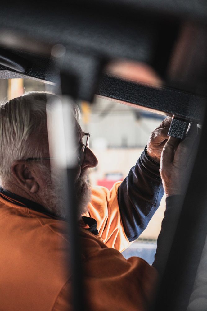 Worker Checking Locks Of Steel Ute Tray — Welding Works in Orange, NSW