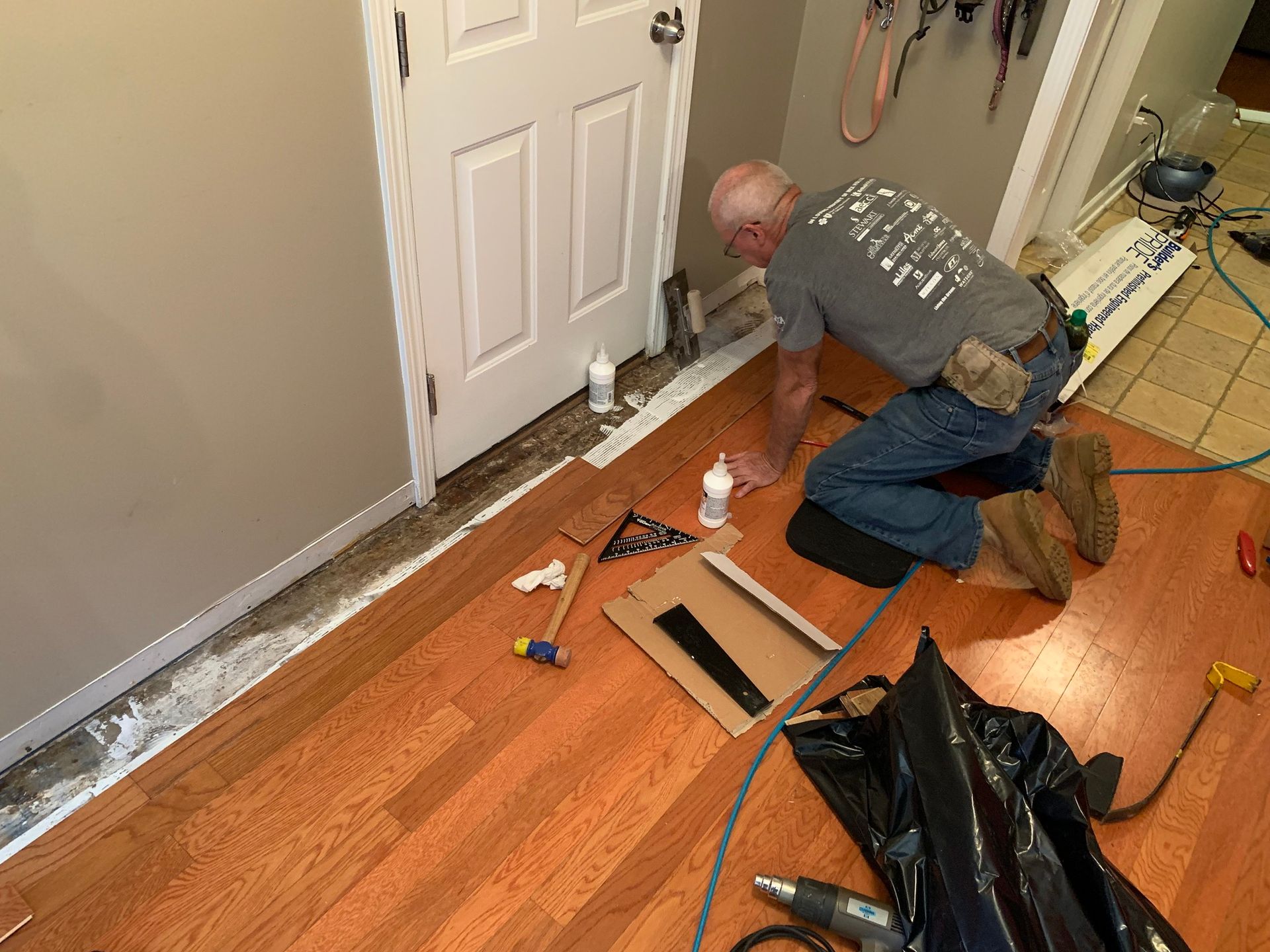 Man Assembling Wooden Floor in the Hallway – Columbus, GA – All Veteran Renovators