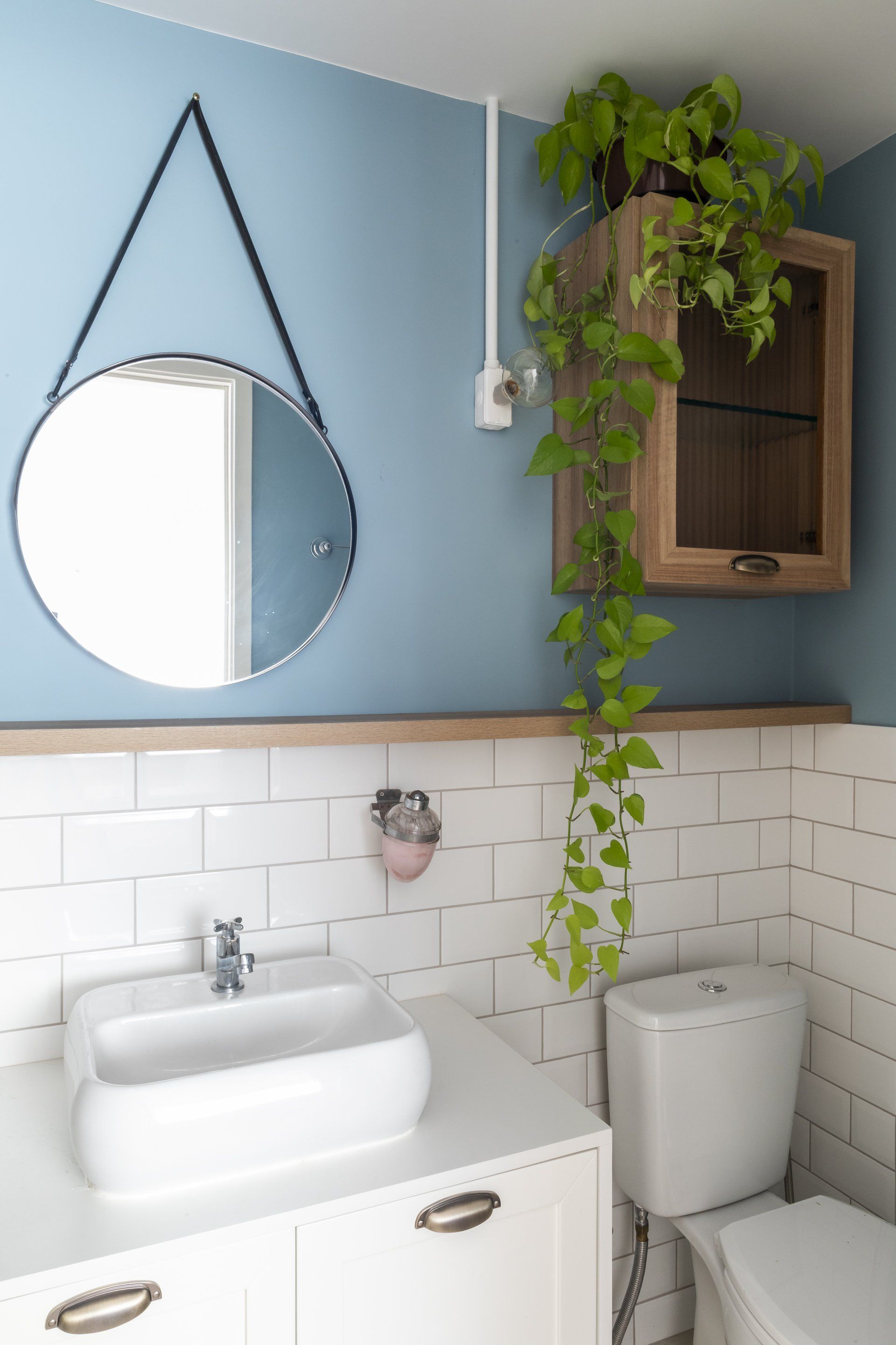 Um banheiro com pia, vaso sanitário e espelho.