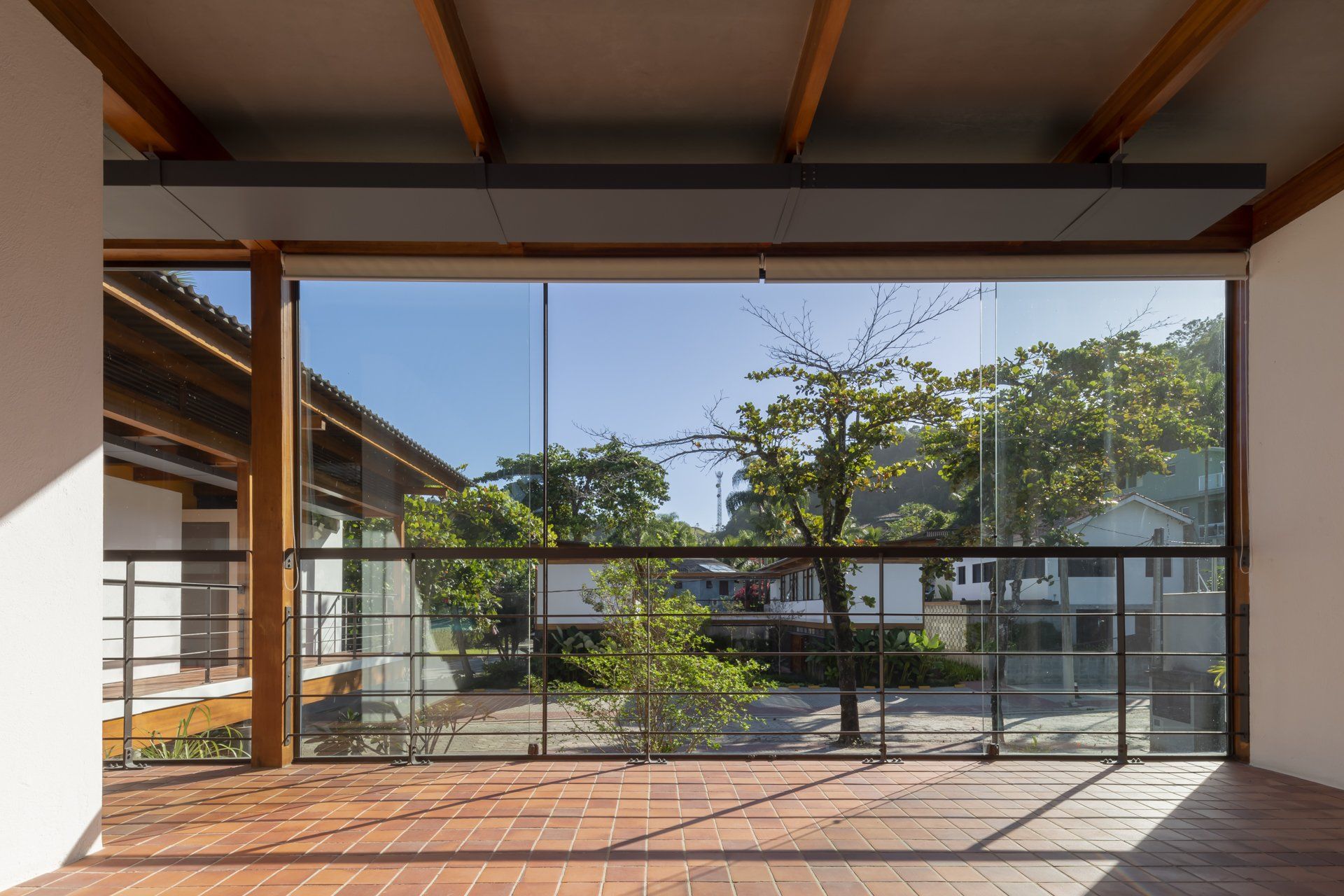 Uma sala vazia com uma grande janela e uma varanda.