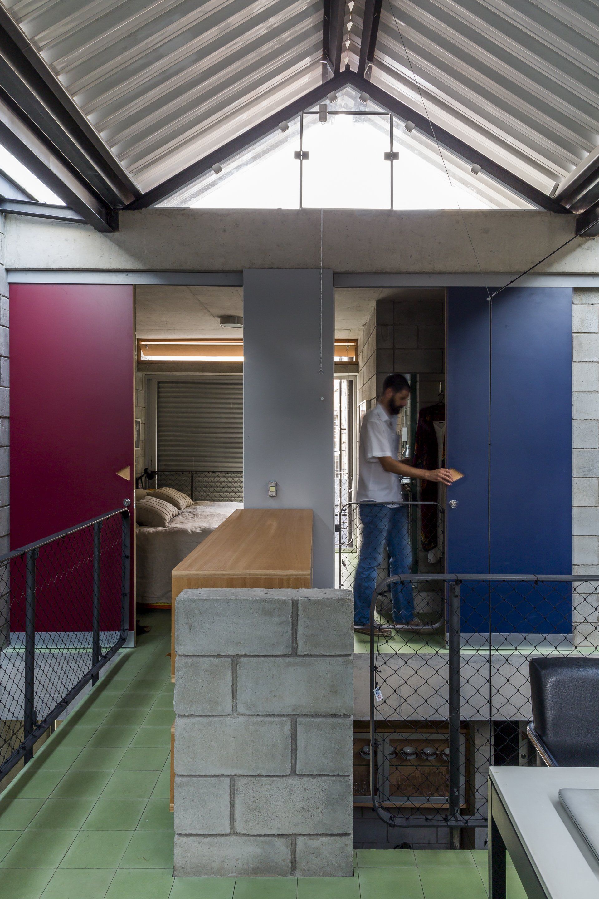 Um homem está parado em uma sala com portas de correr.