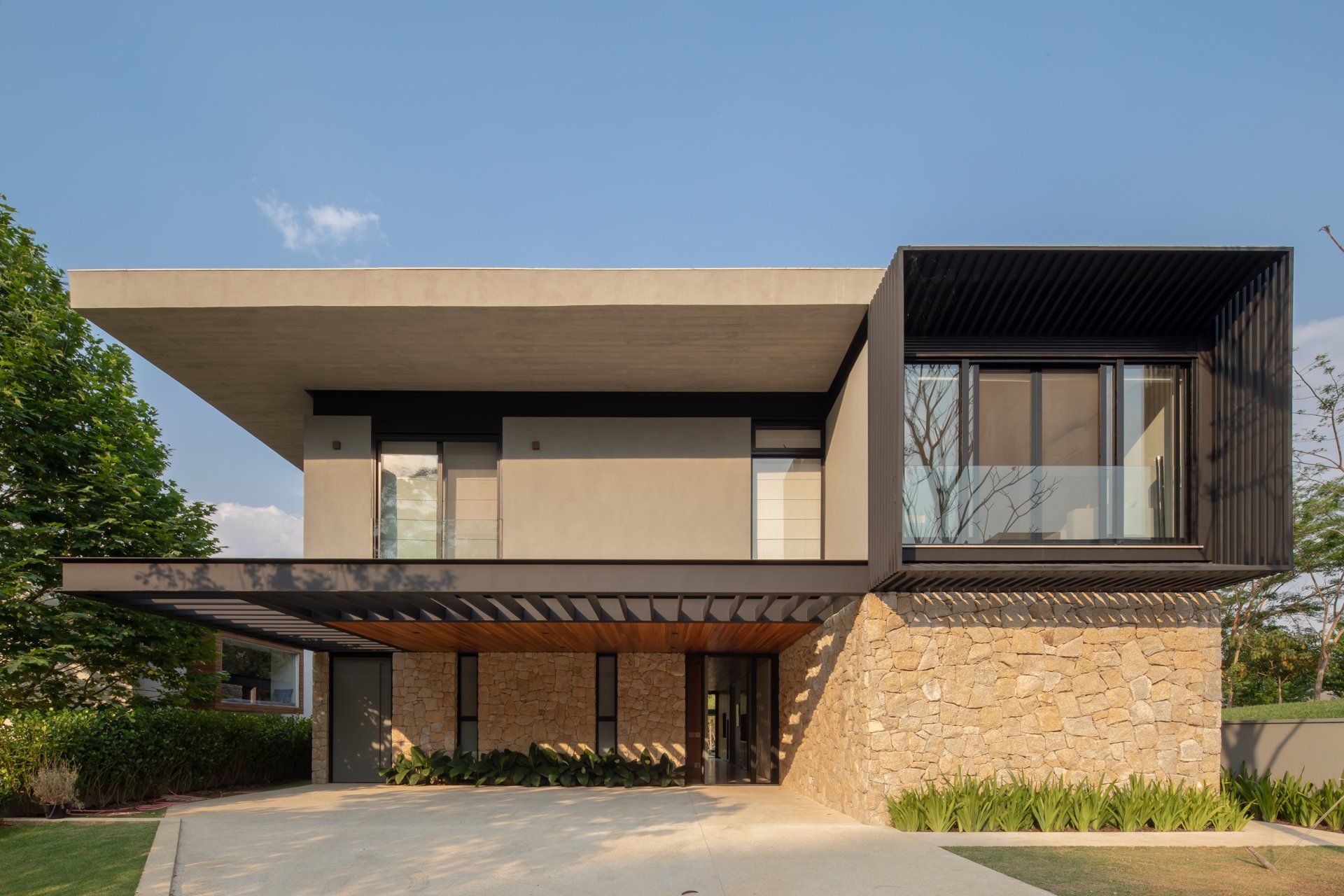 Uma casa moderna com muitas janelas e uma garagem.