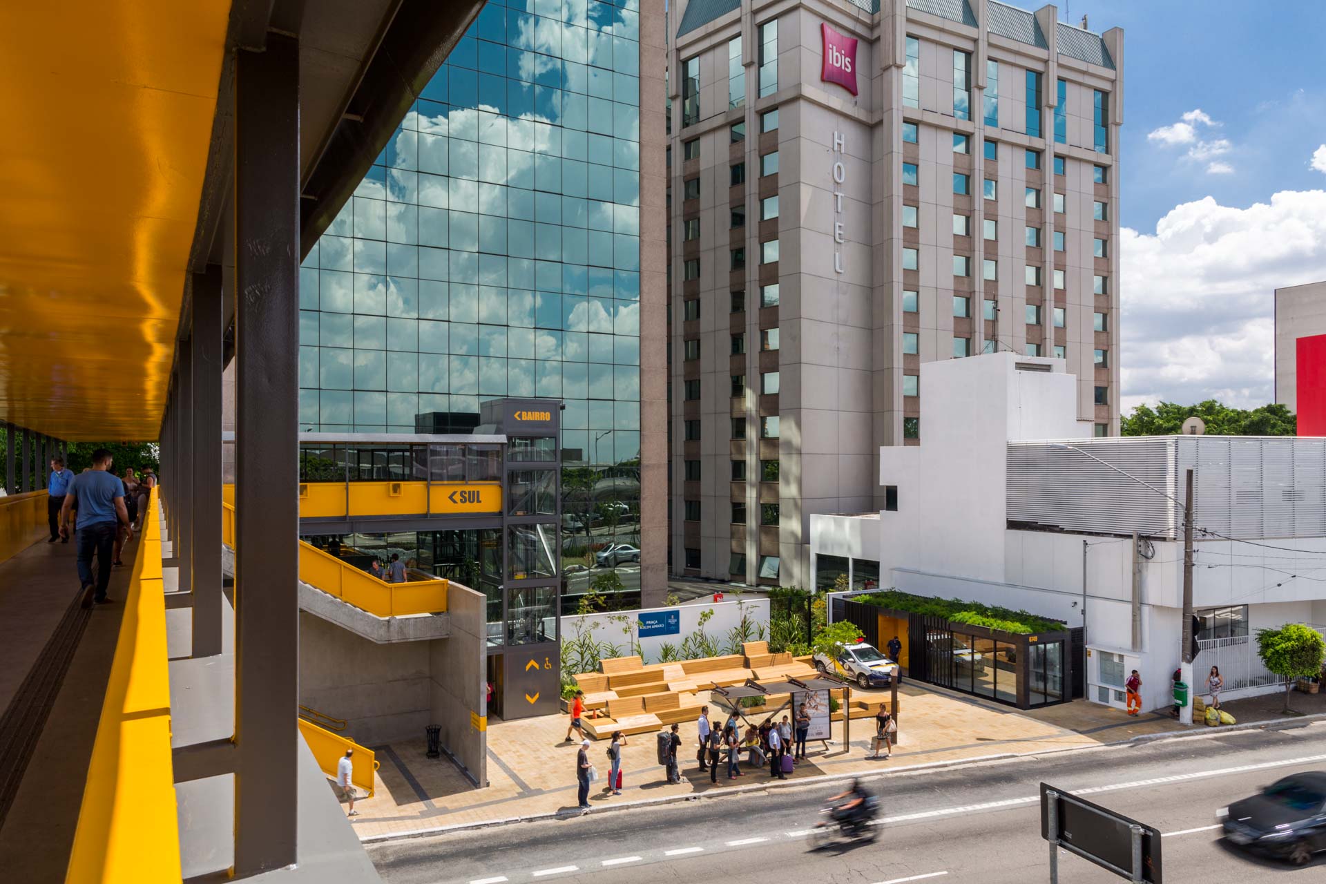 Um grande edifício com muitas janelas fica próximo a uma rua.
