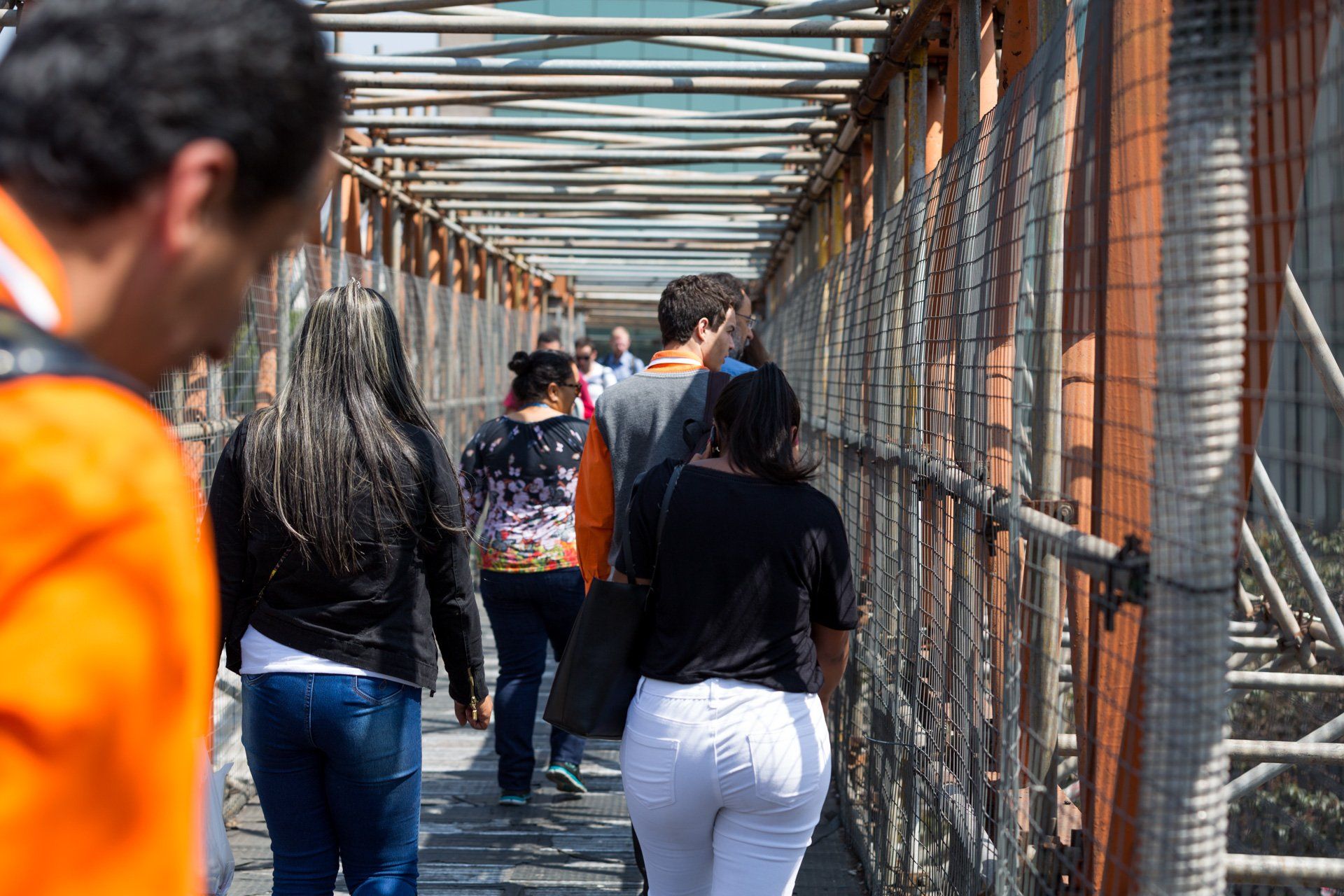 Um grupo de pessoas está atravessando uma ponte.