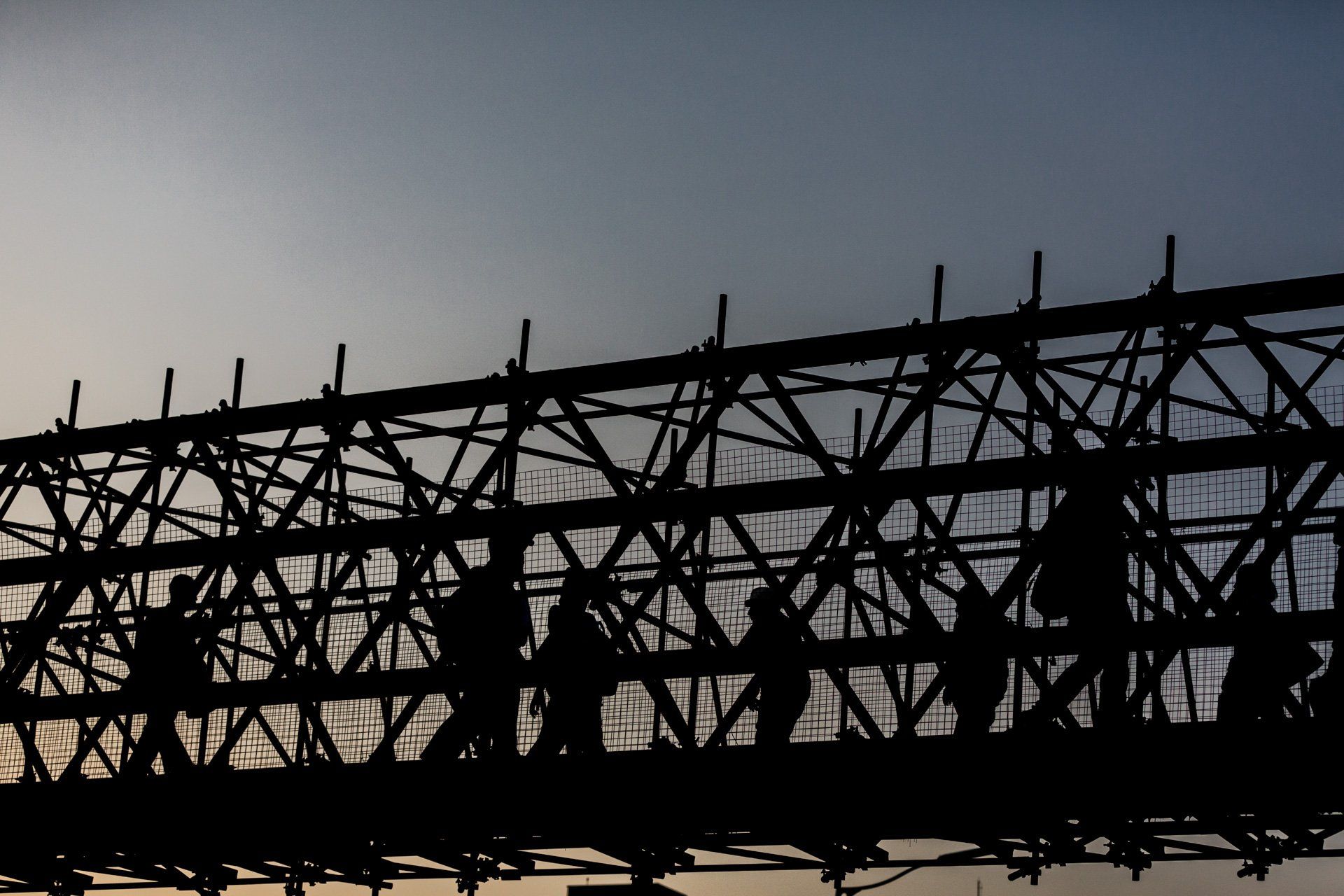 Uma silhueta de uma ponte com um céu azul ao fundo