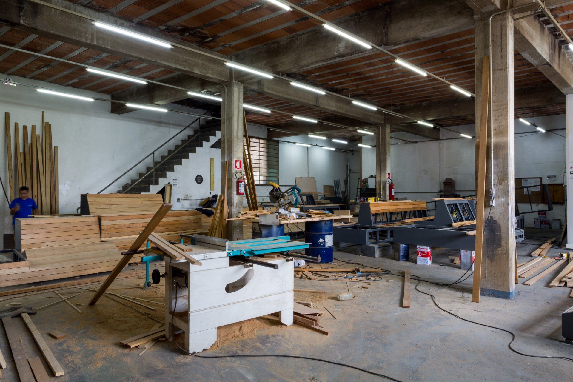 Um grande armazém cheio de madeira e máquinas.