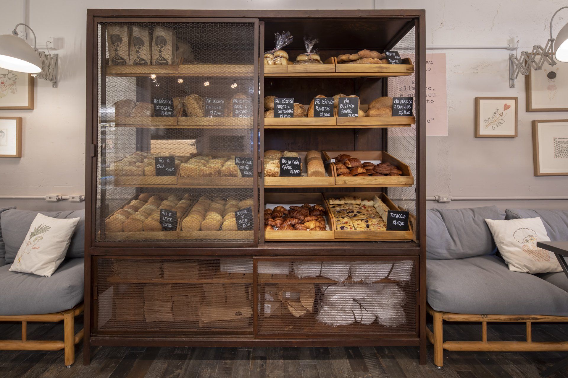 Uma padaria com uma vitrine cheia de pães e doces