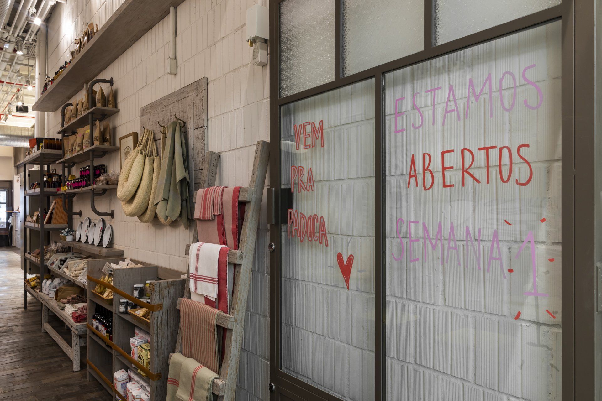 Uma loja com uma placa na porta que diz ``estamos abertos''.