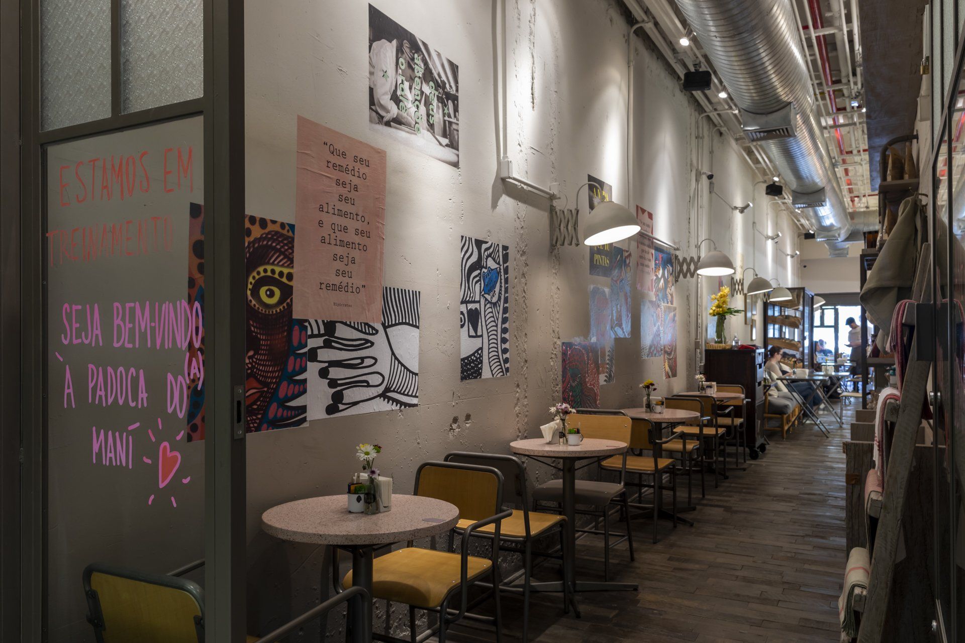 Um longo corredor com mesas e cadeiras em um restaurante.