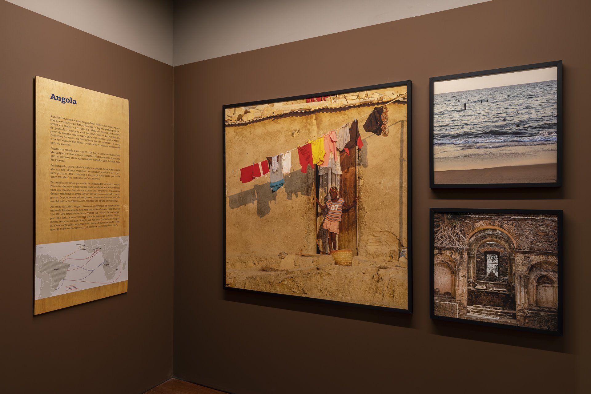 Uma sala com três quadros na parede e uma placa na parede.