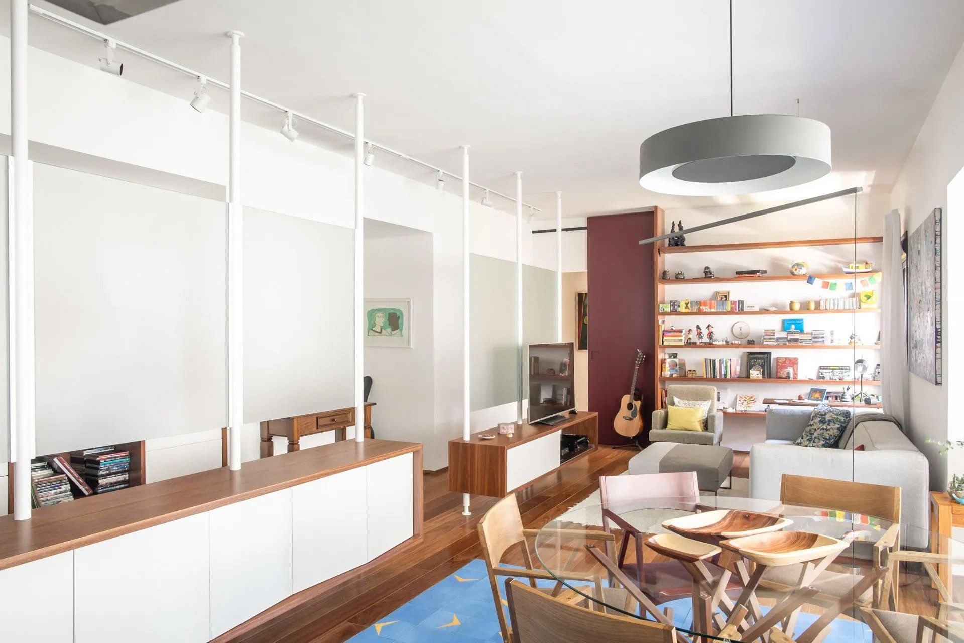 Uma sala de estar com mesa e cadeiras de jantar e um sofá.