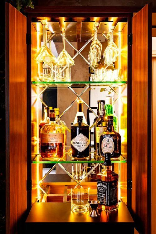 Um bar cheio de garrafas de licor e copos.