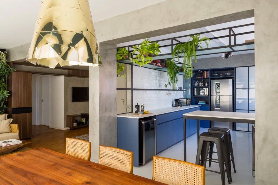 Uma cozinha com mesa, cadeiras, bancos e geladeira.