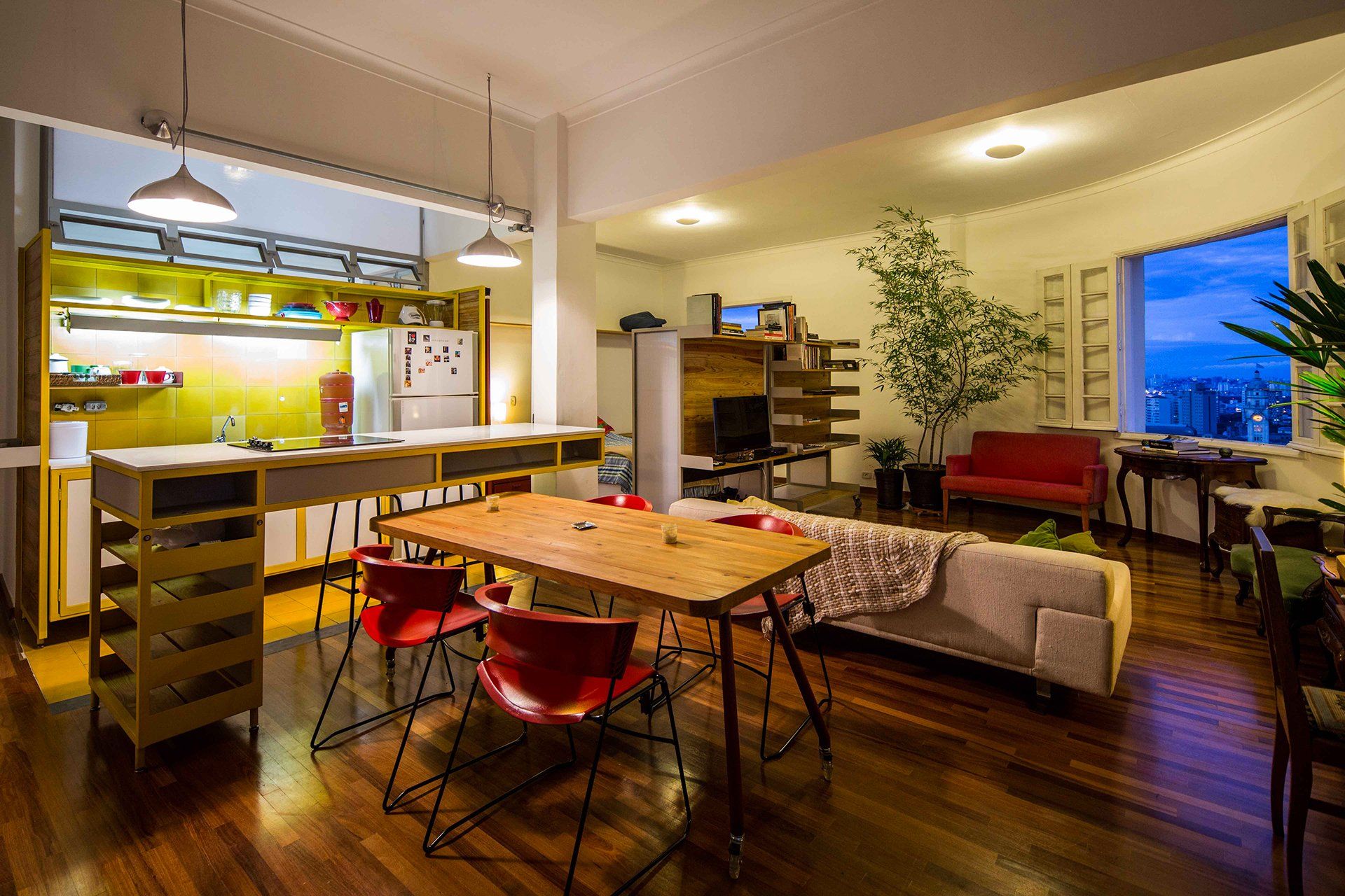 Uma sala com mesa e cadeiras e um sofá.