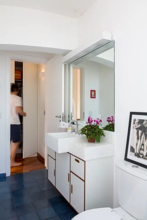 Um banheiro com vaso sanitário, pia e espelho