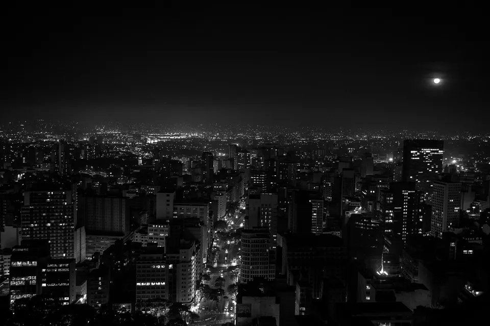 Uma foto em preto e branco de uma cidade à noite