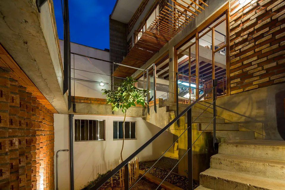Um lance de escadas que leva a um prédio com parede de tijolos.