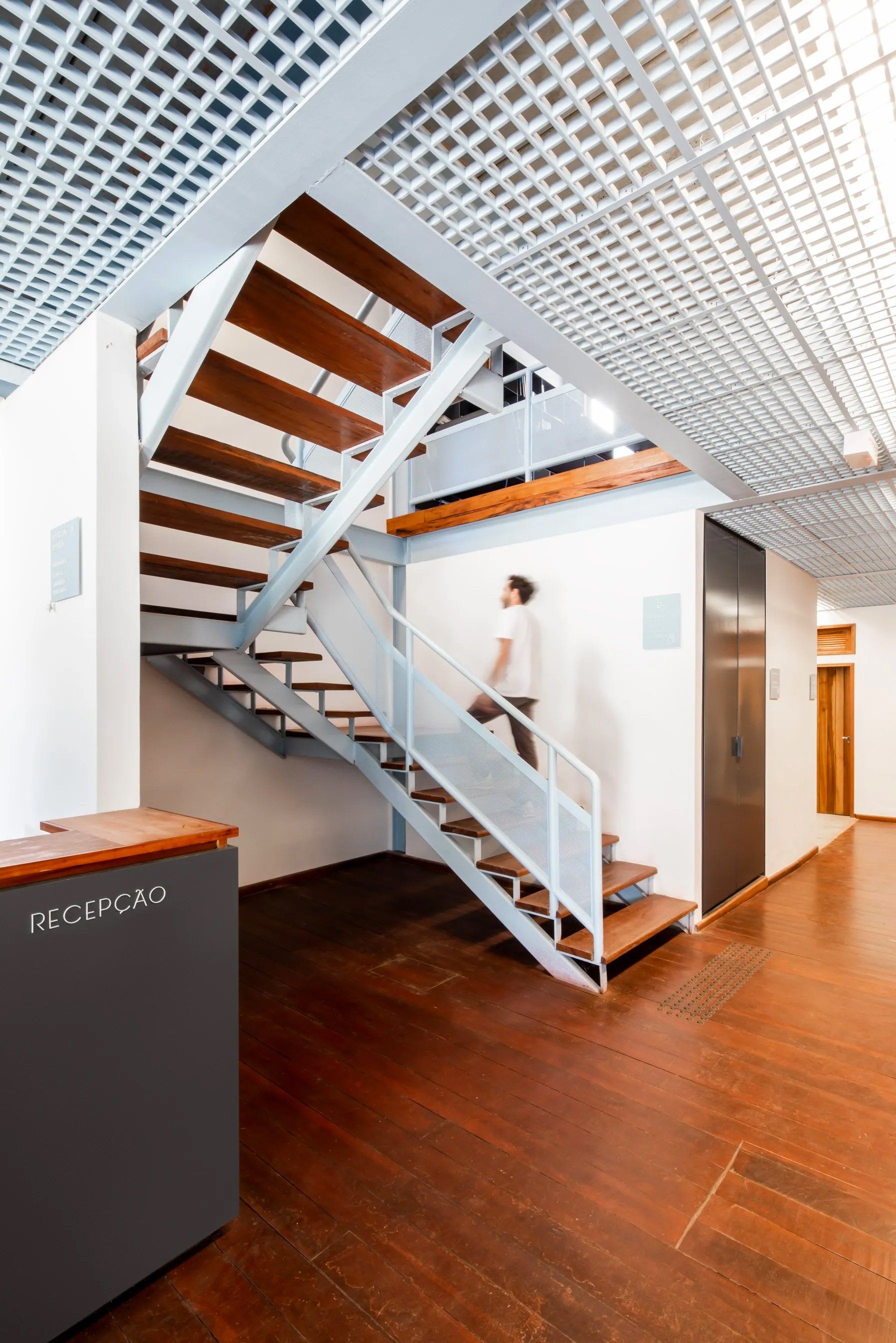 Um homem está descendo as escadas de um prédio.