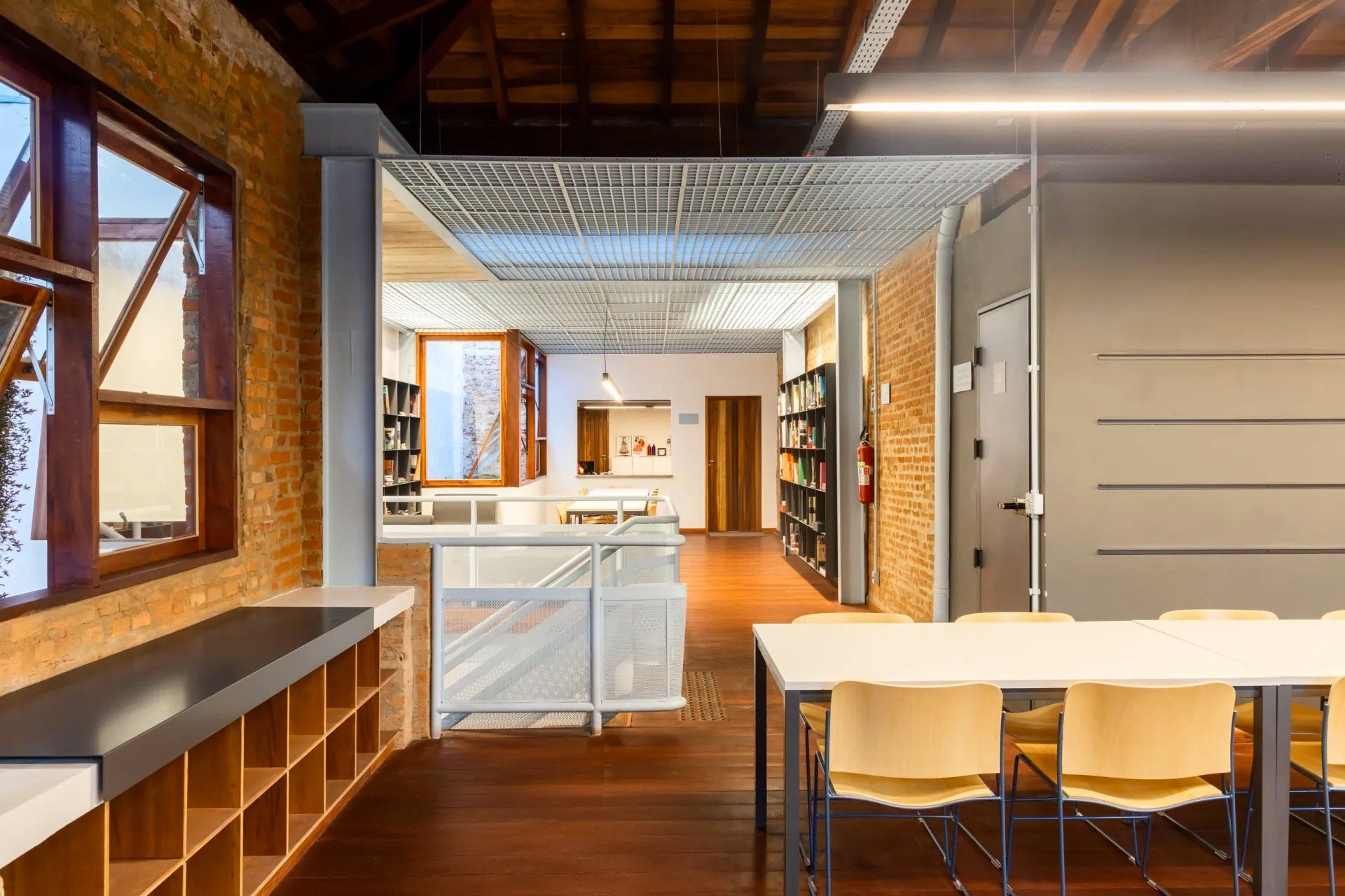 Uma grande sala com mesa e cadeiras.