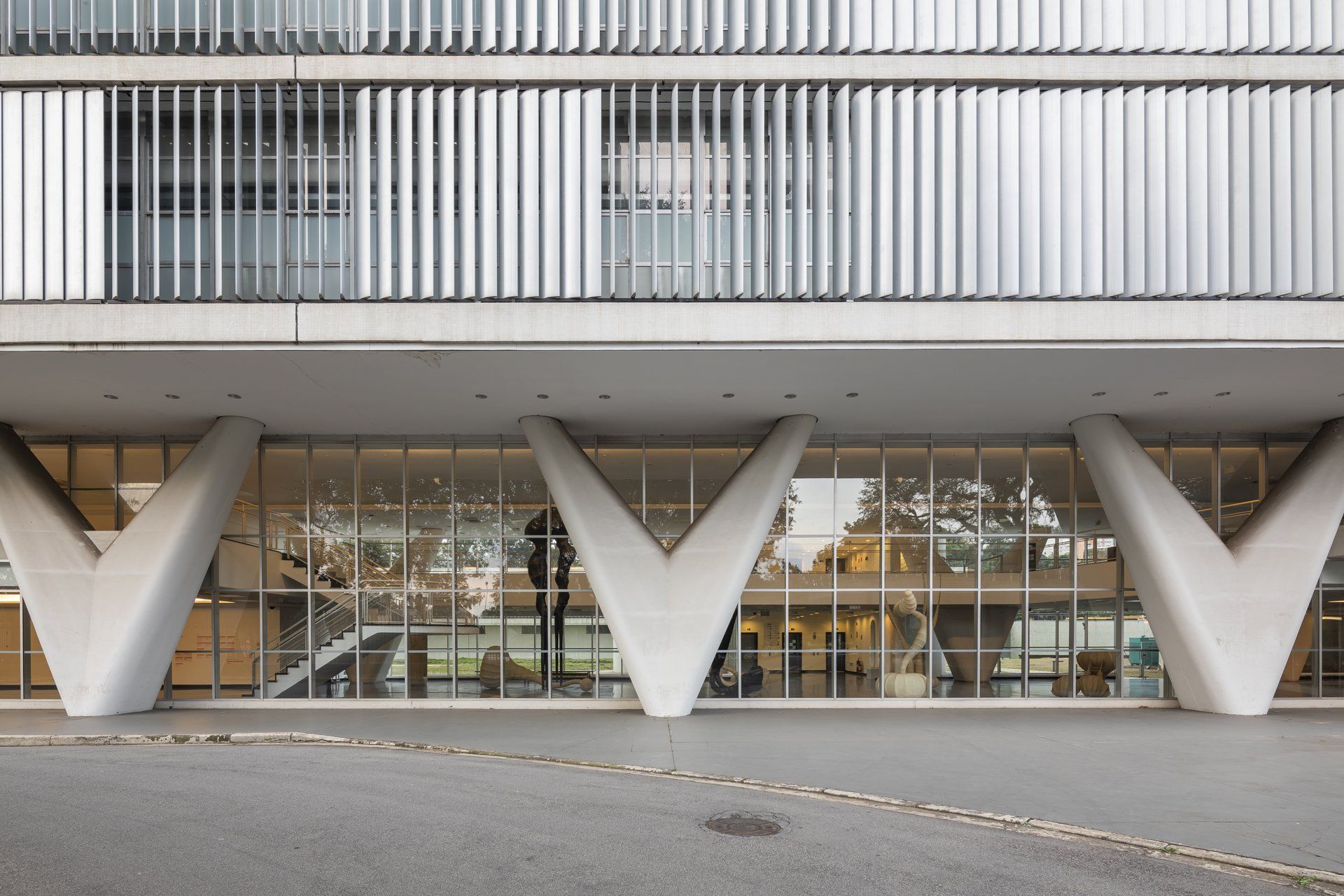 A frente de um prédio com muitas janelas e colunas.