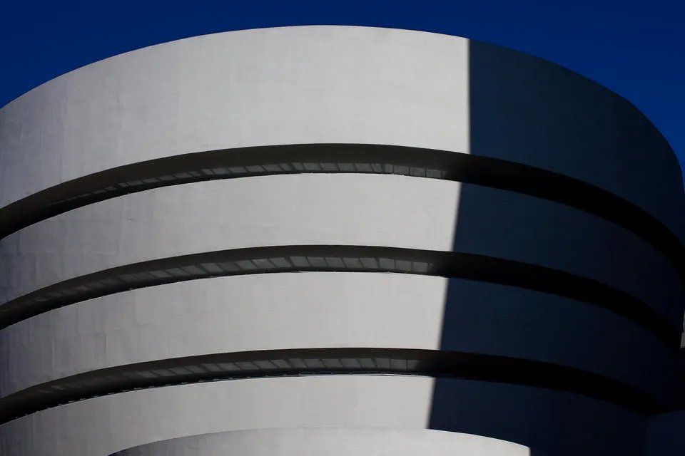 Um prédio branco com um céu azul ao fundo