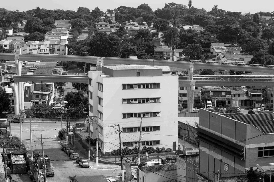 Uma foto em preto e branco de uma cidade com um grande edifício no meio