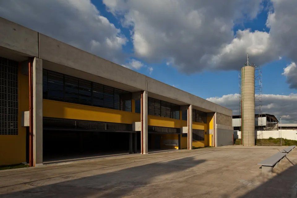 Um grande edifício com muitas janelas e uma torre ao fundo.