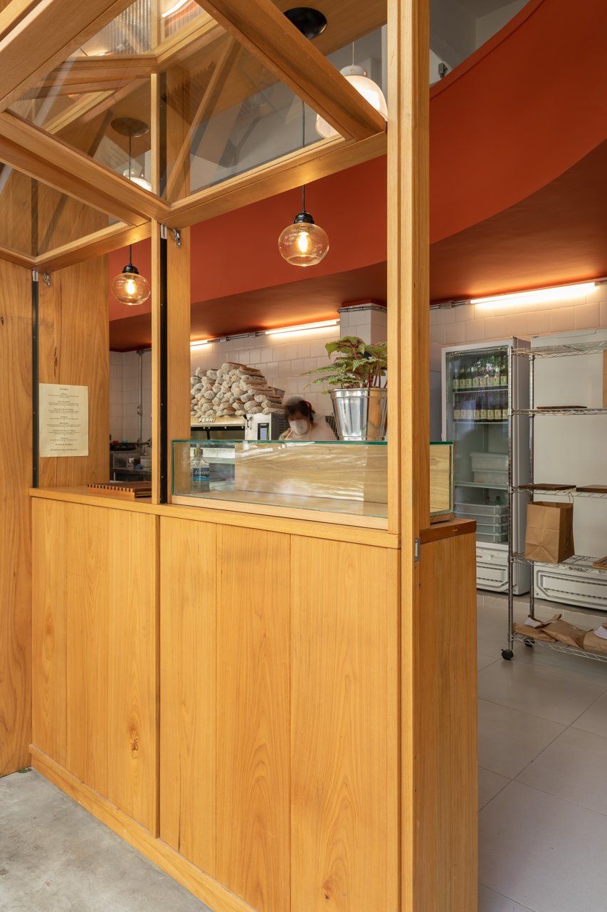 Um balcão de madeira com janela de vidro em um restaurante.