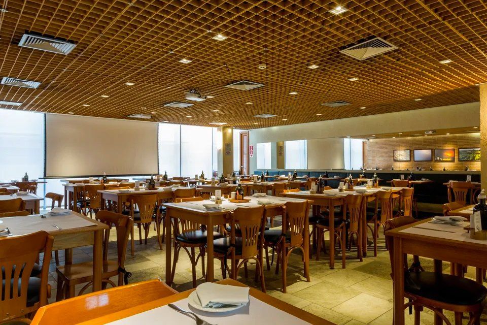 Um restaurante com muitas mesas e cadeiras