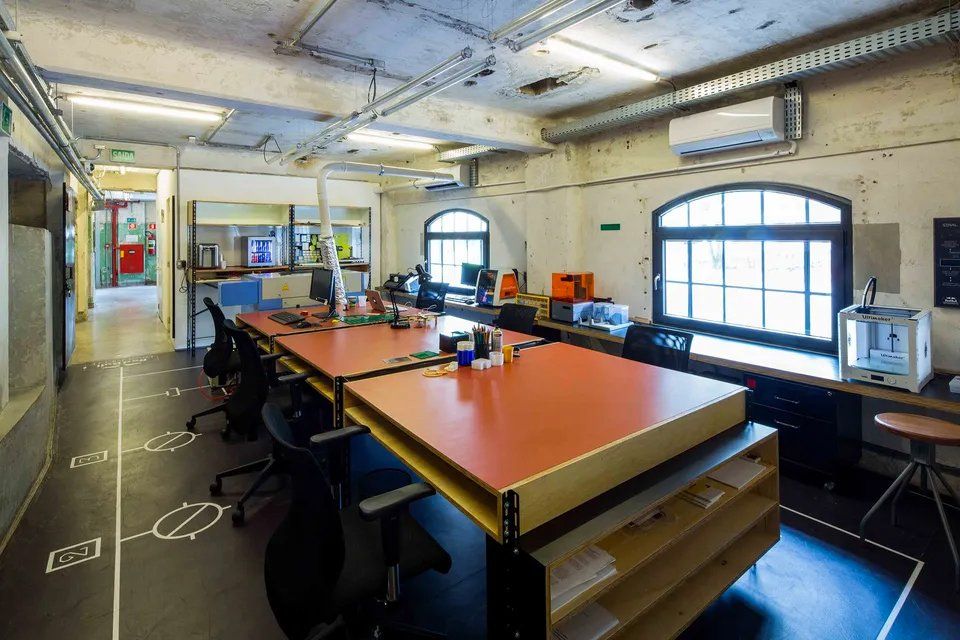 Uma sala grande com muitas mesas e cadeiras