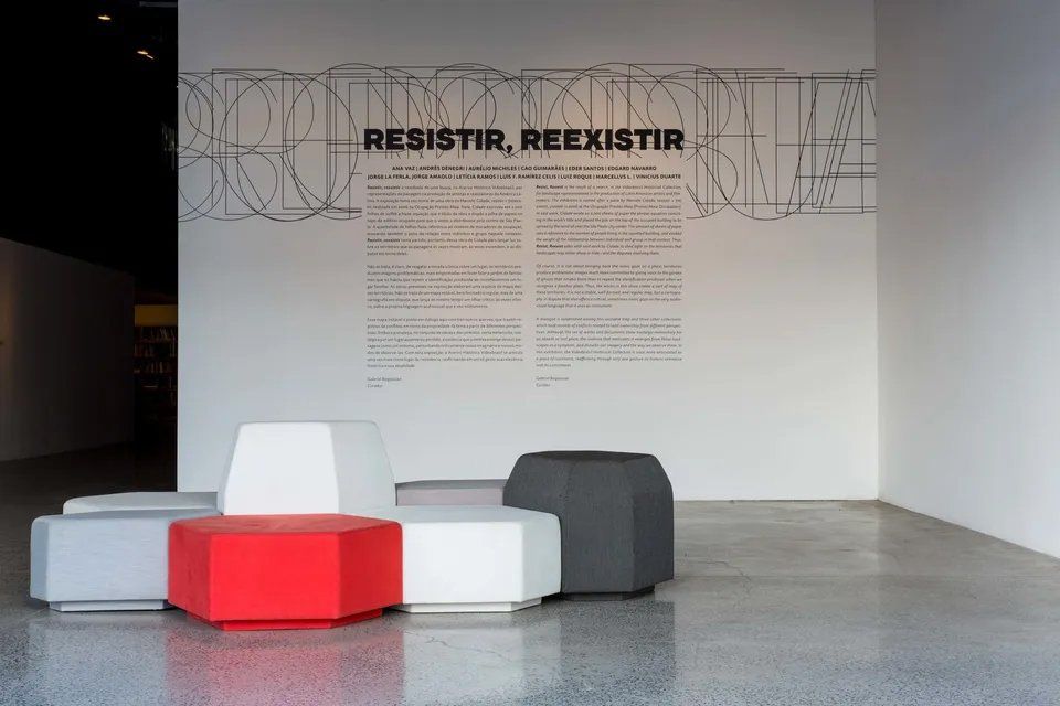 Uma sala com uma parede que diz resistir reexistir nela