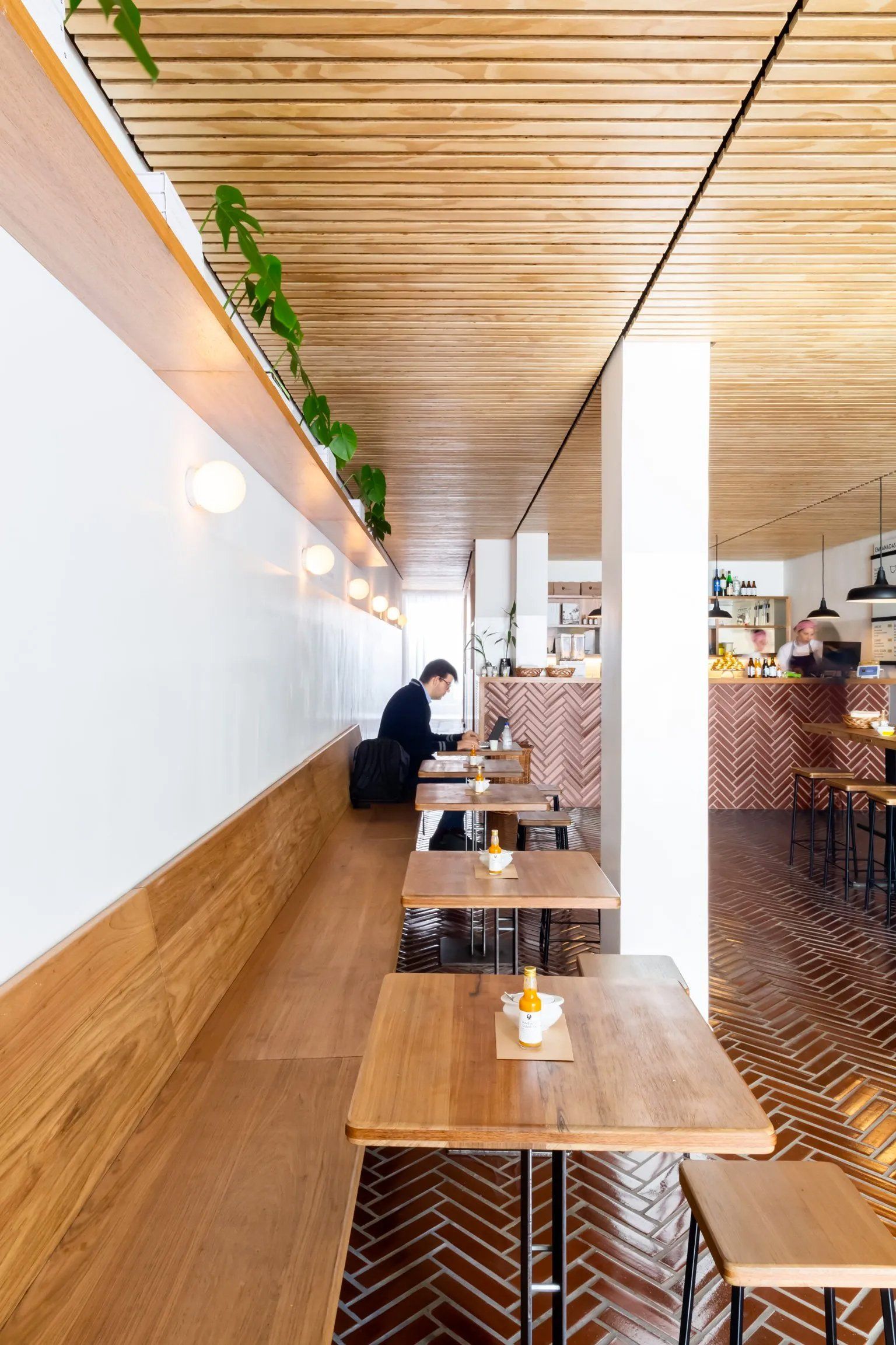 Um homem está sentado à mesa de um restaurante.