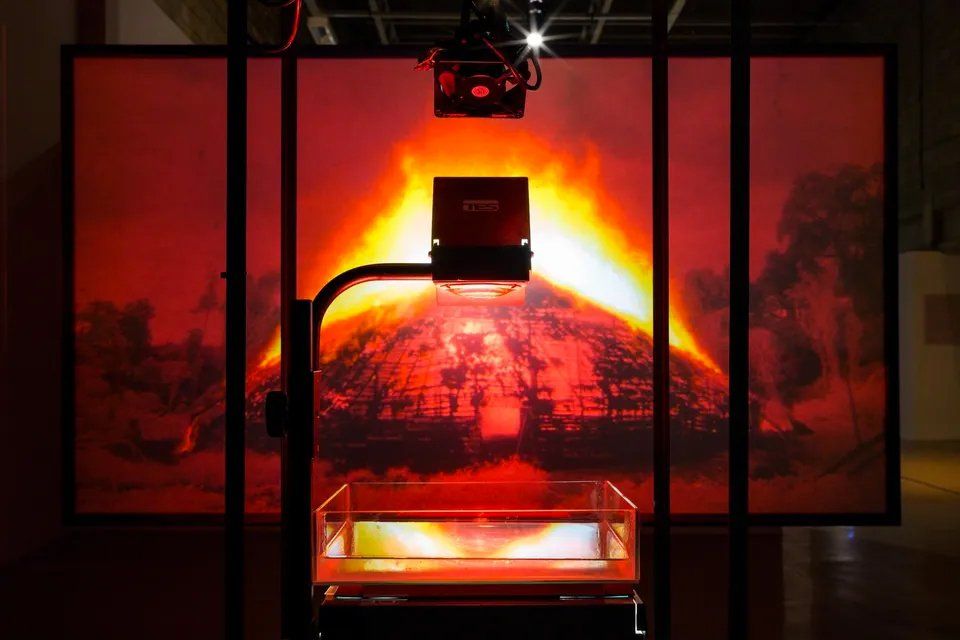 Um projetor está diante da imagem de um vulcão.