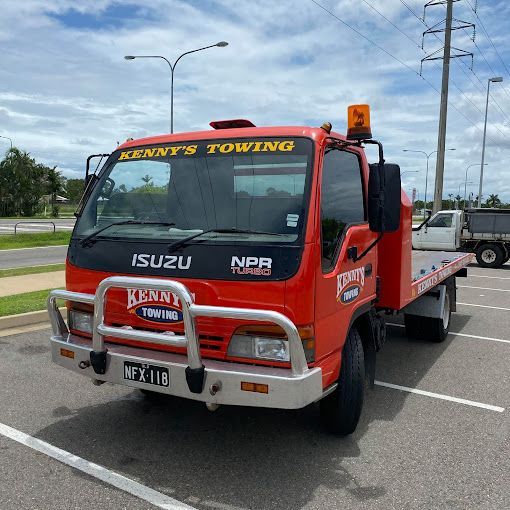 A Red Towing Truck is Parked in a Parking Lot — Kenny's Towing in Jensen, QLD