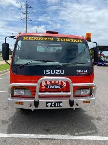 A Red Kenny's Towing Truck is Parked in a Parking Lot — Kenny's Towing in Jensen, QLD