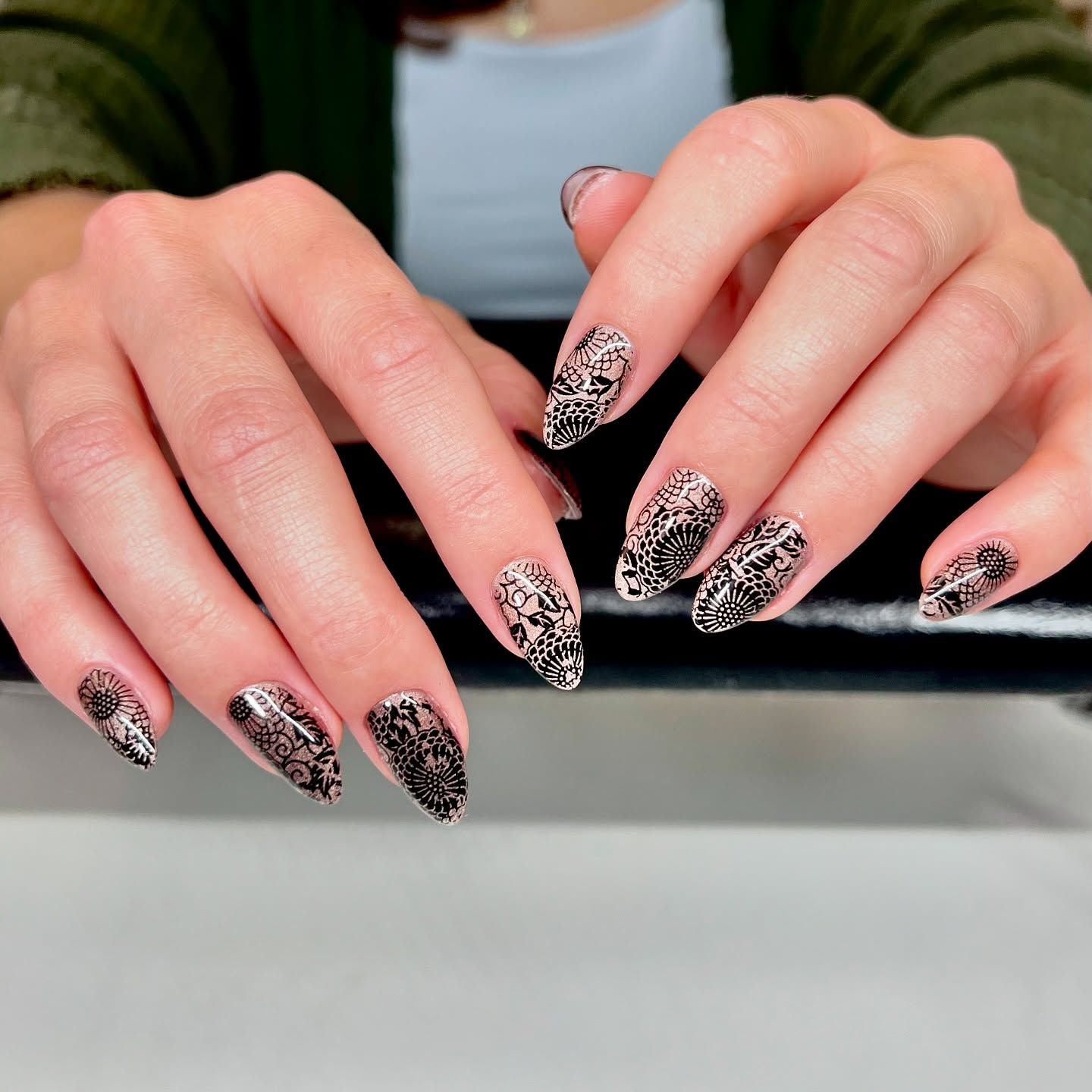 A close up of a woman 's hands with leopard print nails