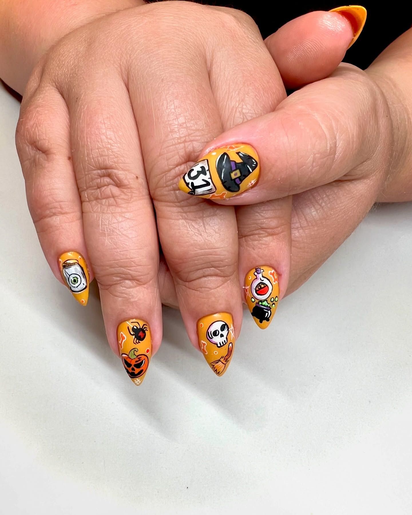 A close up of a person 's hand with halloween nails