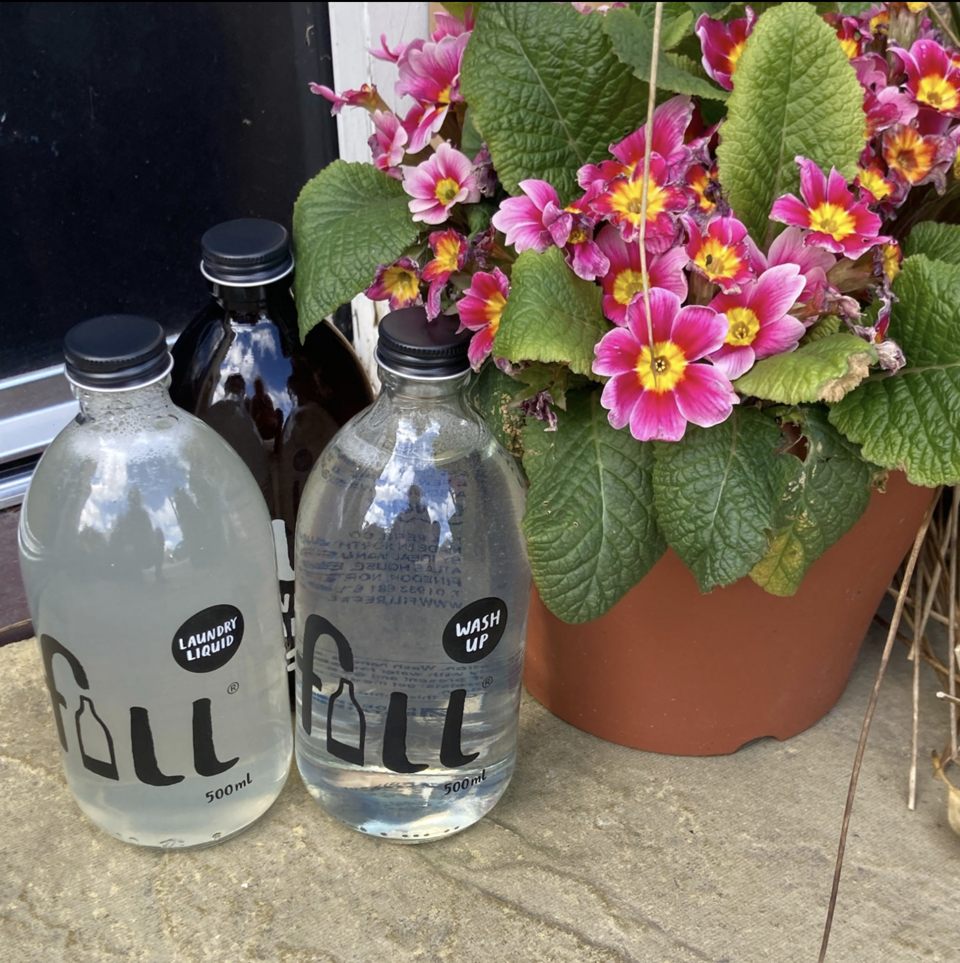 2 refillable containers and flowers