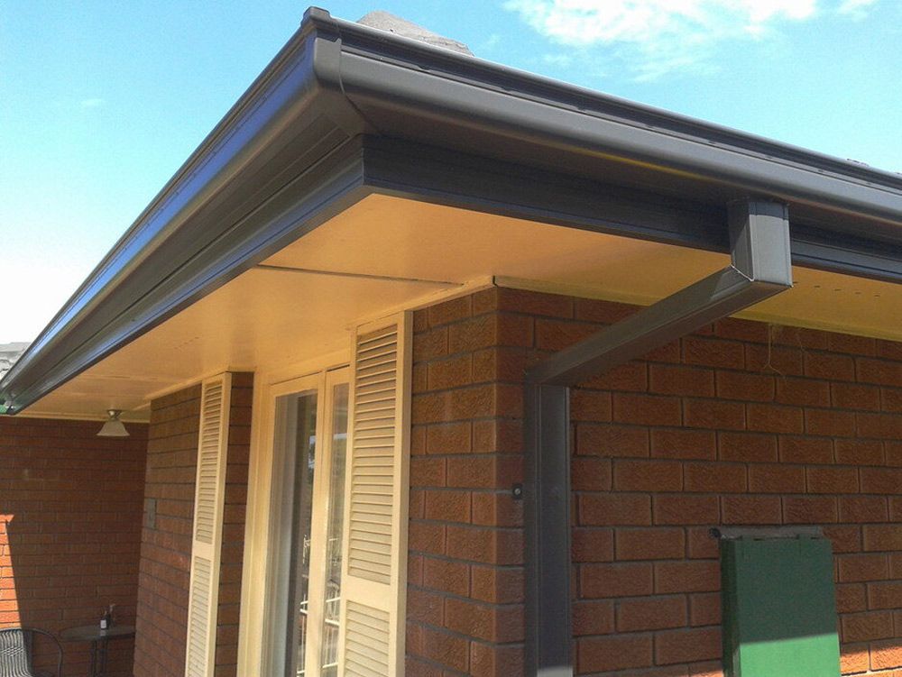 A brick house with a black gutter on the side - Plumbing and Roofing Port Macquarie NSW