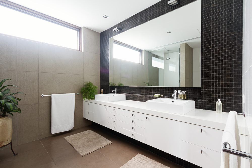 A bathroom with two sinks and a large mirror - Plumbing and Roofing Port Macquarie NSW