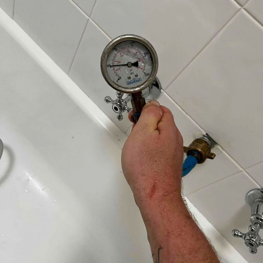 Plumber Fixing Hot Water System