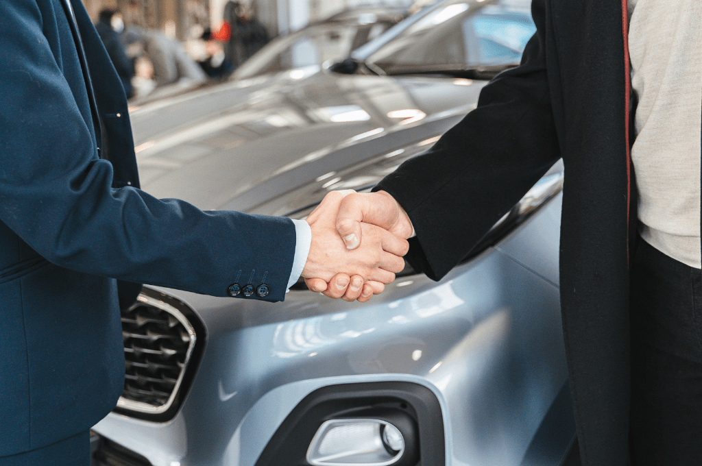 shaking hands after giving his car for shipping