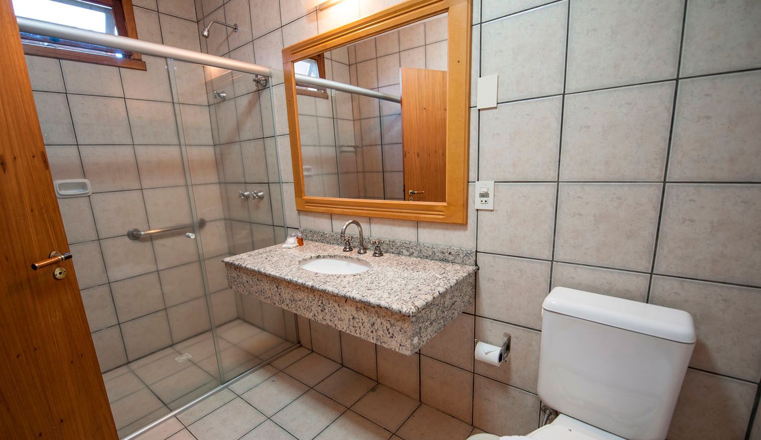 um banheiro com vaso sanitário, pia e espelho