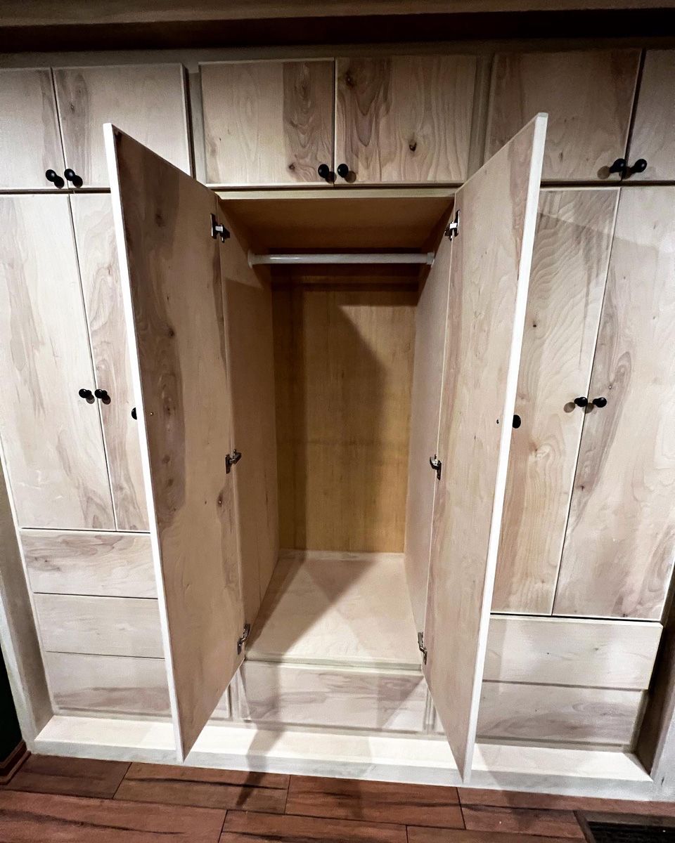 The inside of a wooden cabinet with the doors open