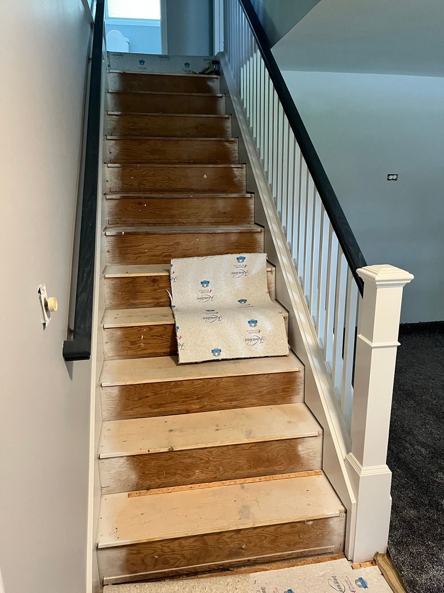 A staircase is being painted in a house.