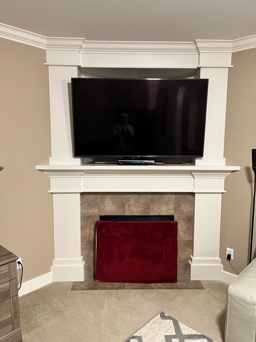 A living room with a fireplace and a flat screen tv.