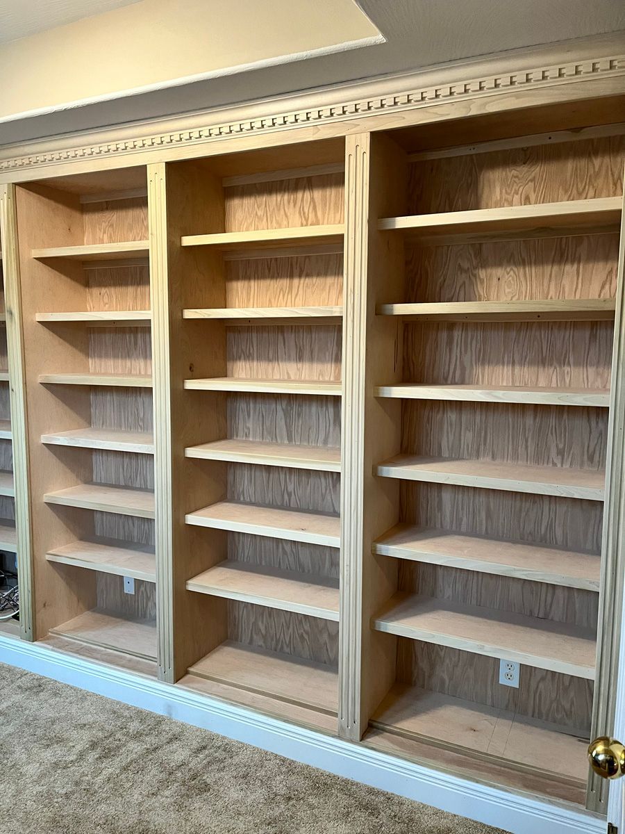 A room with a lot of shelves and a door.