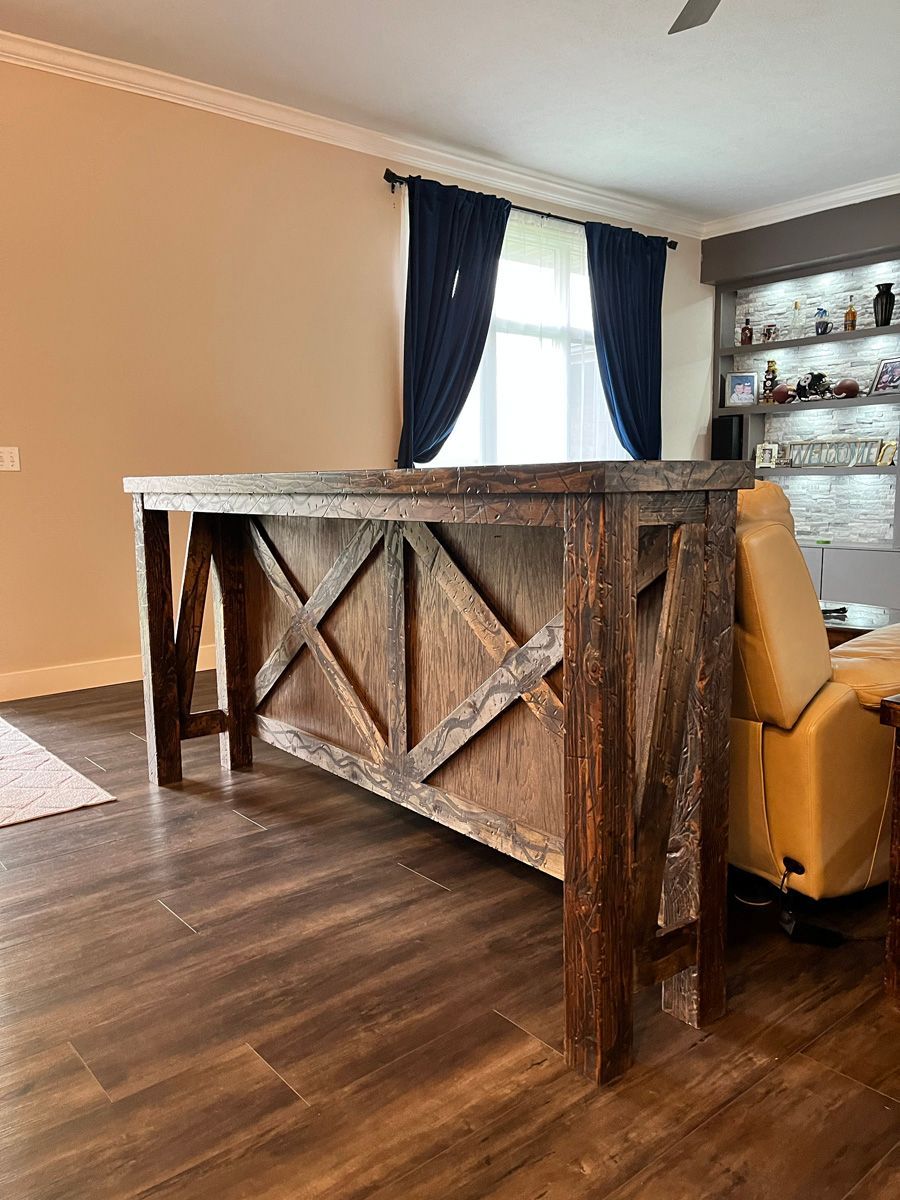 A wooden table is sitting in a living room next to a couch.