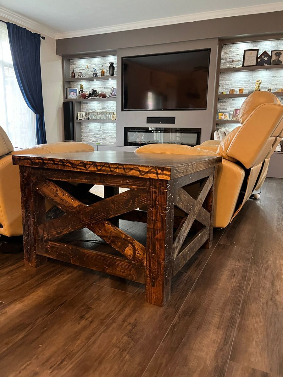 A living room with a wooden coffee table and a flat screen tv.